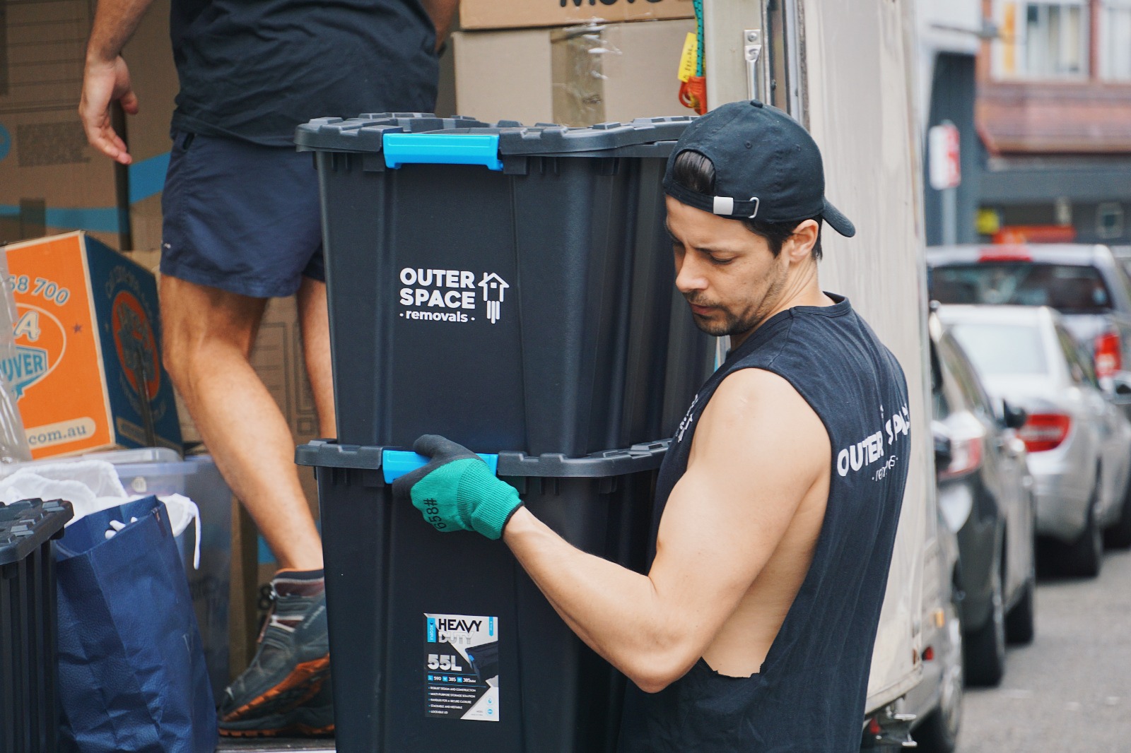 Outer Space Removals removalists carrying packed crates to the truck