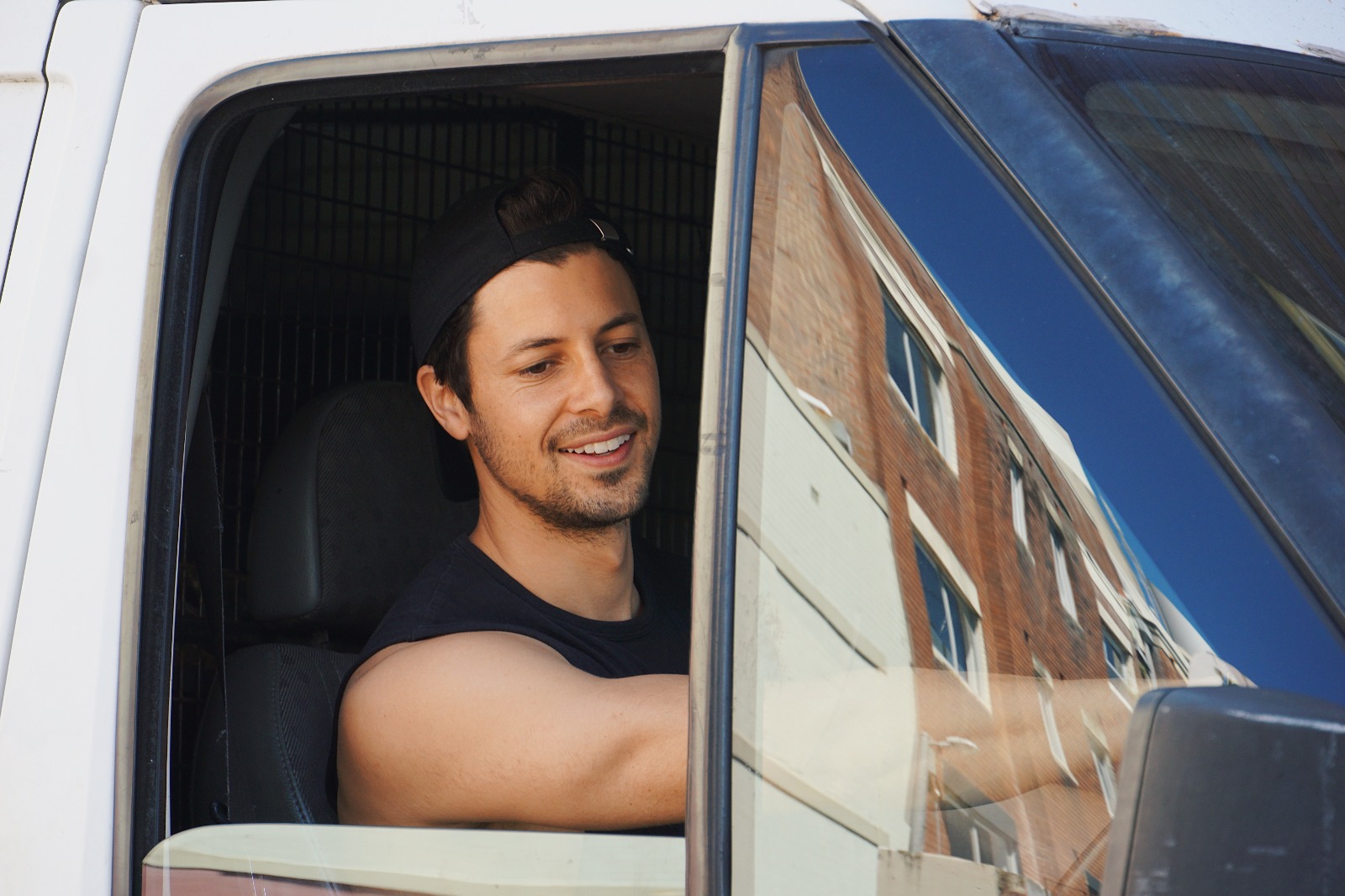Outer Space Removals driver at the wheel of the removal truck